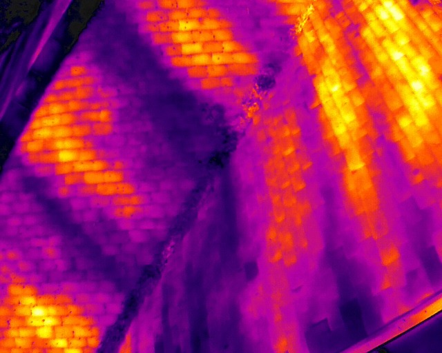 Thermal close-up of brickwork and roof slopes showing heat retained in the masonry