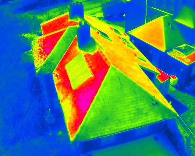 Thermal aerial image of several rooftops with warm ridges and a rooflight