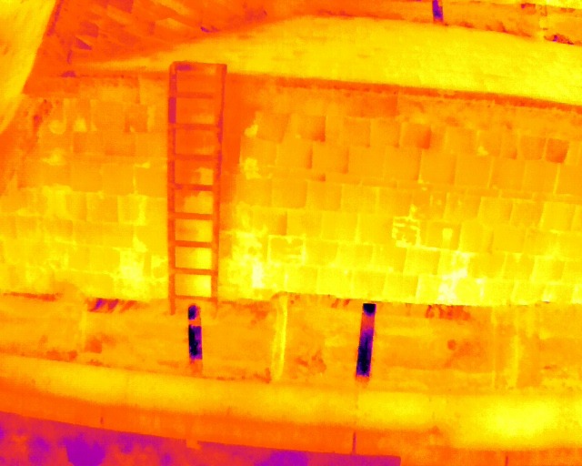 Thermal drone image of a wall with a ladder against it