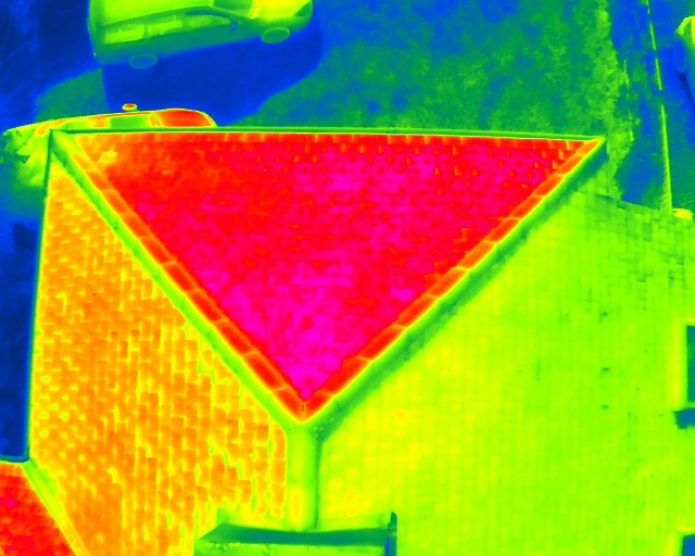 Thermal aerial image of a hipped roof showing a hot pink section of heat loss